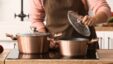 Woman,cooking,in,copper,pot,at,home