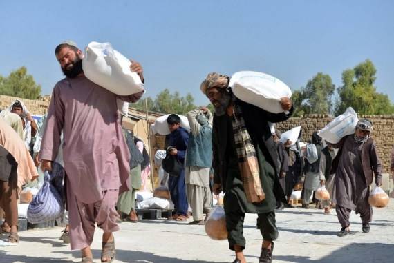 People Carry Relief Supplies Donated By World Food Programme In Kandahar Afghanistan. Photo By Sanaullah Seiamxinhuaians